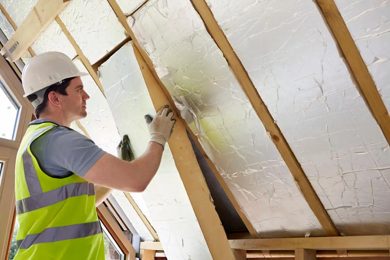 Rigid PIR insulation boards fitted between loft rafters Chingford